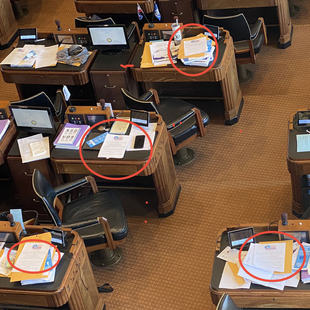 images of legislators having health freedom louisiana handouts on their desks. donate today!