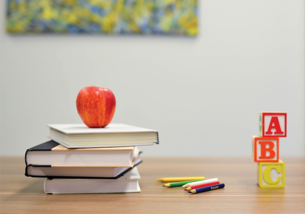 photo of school books and an apple